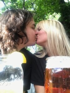 tarin and adam kissing with beer